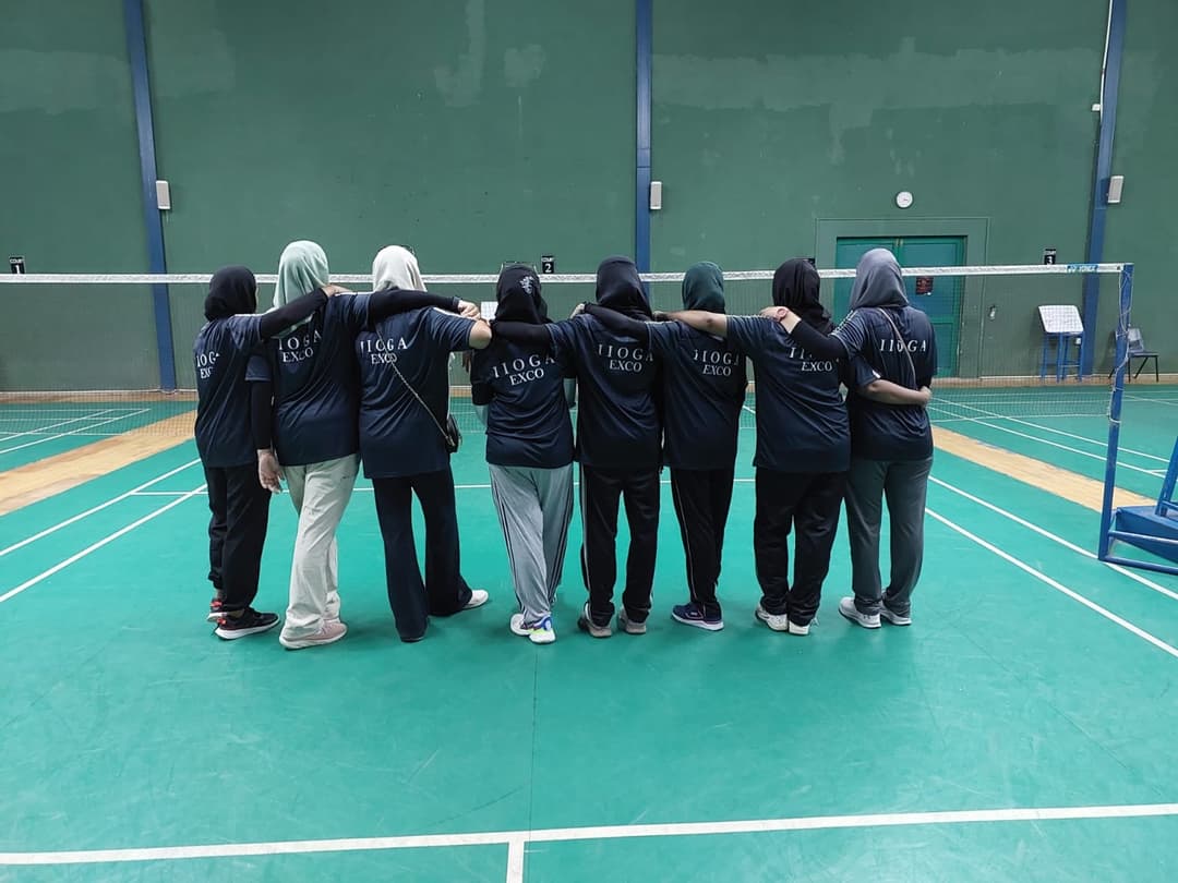 IIOGA badminton squad lined up at the indoor stadium court